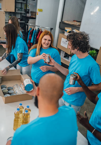 istock Volunteers packing food in donation boxes 1456460254