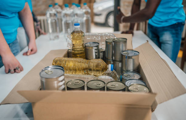 istock Volunteers with groceries in boxes for donations 1456461072