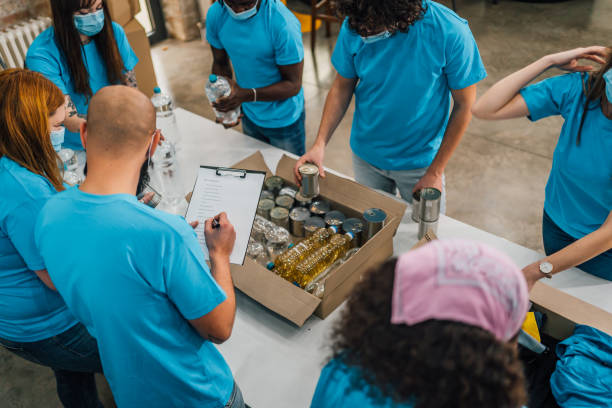 istock Diverse volunteers team packing donation boxes 1456461222