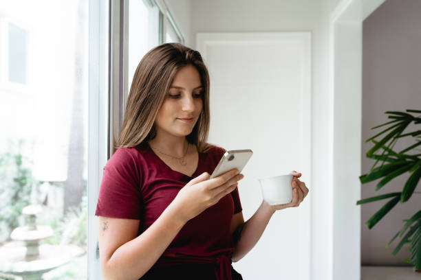 istock Woman using smartphone in the morning 1456463220