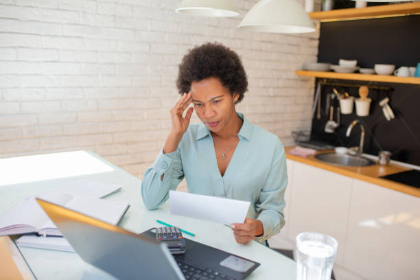 istock Woman planning home budget and using calculator 1456466727