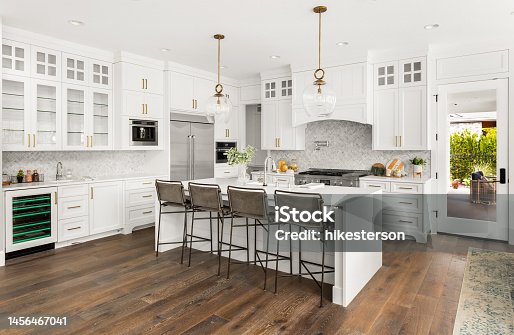 istock Beautiful kitchen in new farmhouse style luxury home with island, pendant lights, and hardwood floors. 1456467041