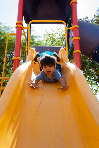 Hispanic toddler playing in a playground in the morning