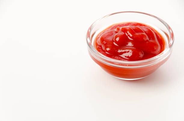 istock tomato ketchup in a small glass bowl on a white background 1456468610