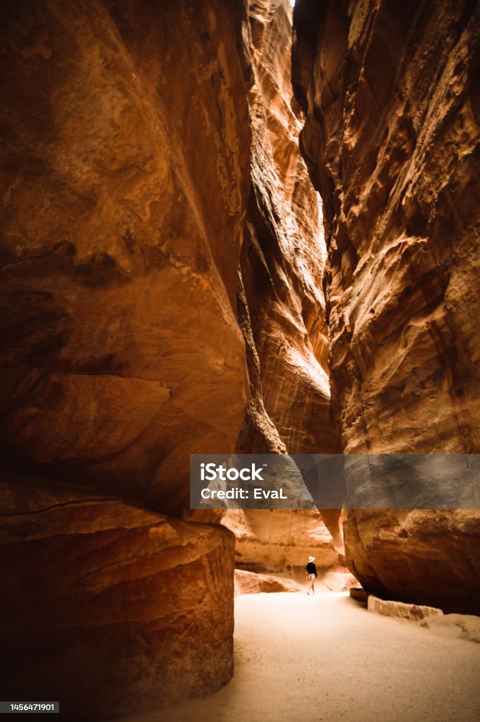 The Siq, the narrow slot-canyon that serves as the entrance passage to the hidden city of Petra, Jordan Ancient Stock Photo