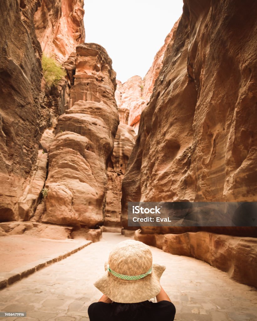 Tourist in Petra take photograph of The Siq, the narrow slot-canyon that serves as the entrance passage to the hidden city of Petra. Sightseeing destination of Jordan 35-39 Years Stock Photo