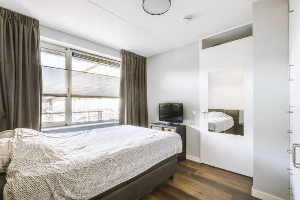 istock Light bedroom with wooden wardrobe 1456472476
