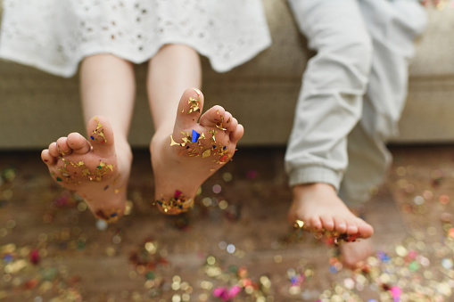 The children's bare feet with confetti on their feet