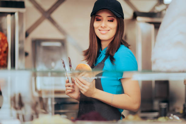 istock Happy Fast Food Employee Working Making a Sandwich for Customers 1456475139