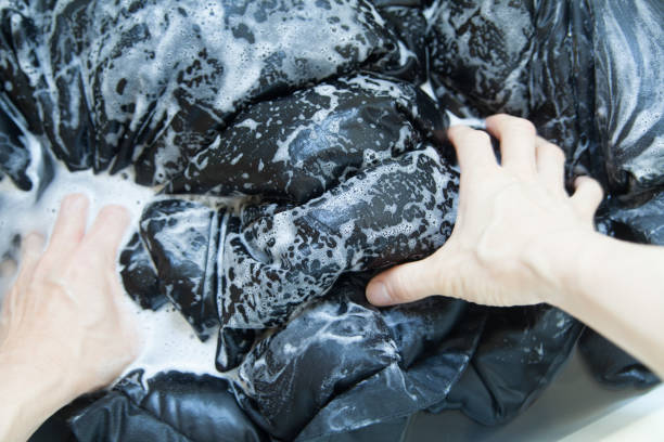 istock hand washing down jacket in bathtub 1456480775
