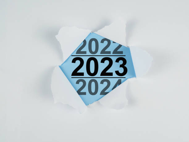 istock Torn paper with new year text 2023 on blue background. 1456486569