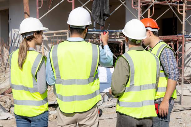 istock Team group of contractor and architect with foreman explaining about scheme building site for planning project to worker and looking blueprint, construction site, development and structure. 1456487348
