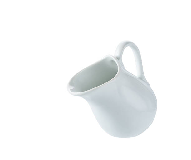 istock small milk jar or creamer isolated on white background. 1456491263