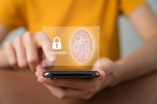 istock Hand using smartphone and press scan fingerprints to confirm your login, private data and prevent identity. 1456498245