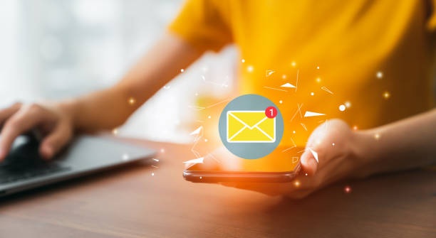 istock Hand holding smartphone and shows a digital screen of new email notifications. 1456498279