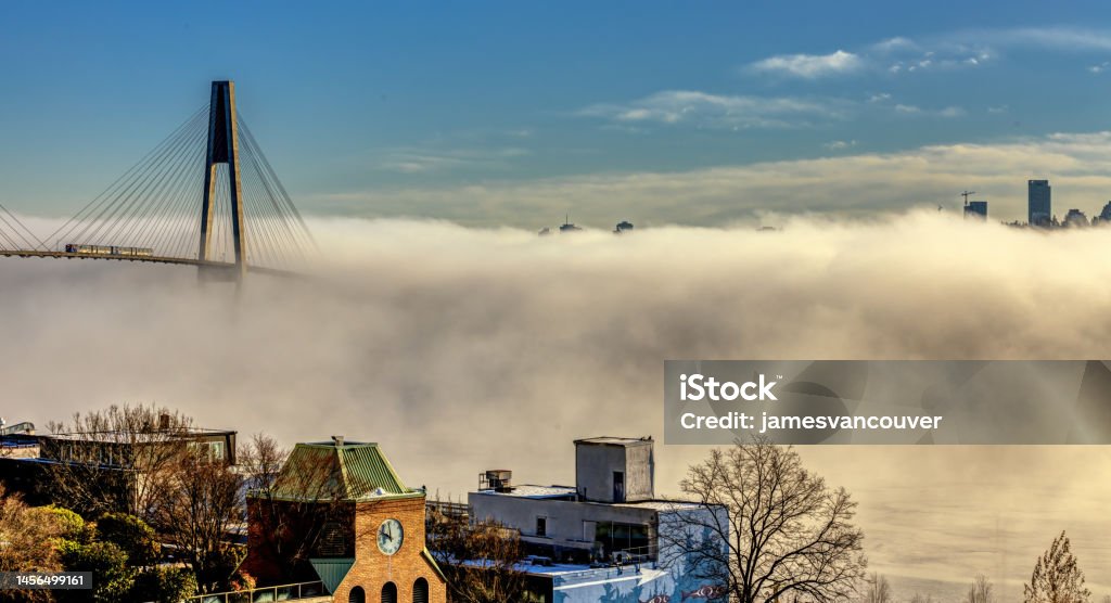 Panorama of beautiful fog covering city and bridge in an evening Canada Stock Photo