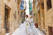 Happy travelers in old Mediterranean town