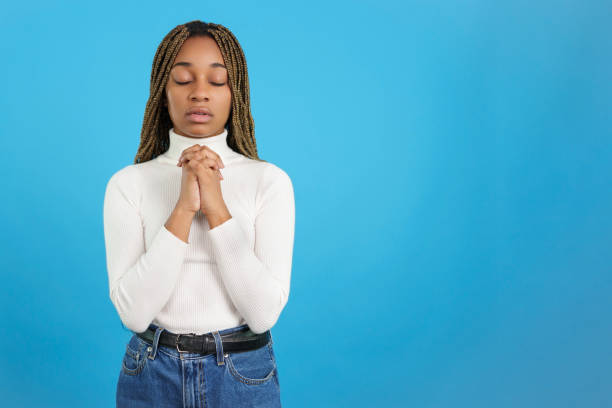 istock African woman with folded hands in prayer 1456499395