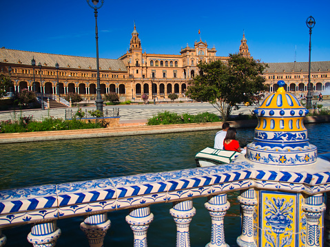 Plaza de Espana, Seville, Spain - July 08 2019 : A view of the tiled handrail which surrounds the beautiful government building which was once used as a setting for a Star Wars film.