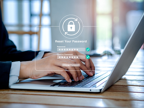 Reset password concept. Lock icon, security code showing on change password page while business person using laptop computer in office. Cyber security technology on website or app for data protection.