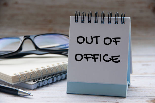 Out of office text on calendar desk with notebook and glasses background. Out of office concept. Out of office text on calendar desk with notebook and glasses background. Out of office concept after work stock pictures, royalty-free photos & images