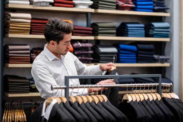 istock Handsome man is choosing clothes in the store 1456515301