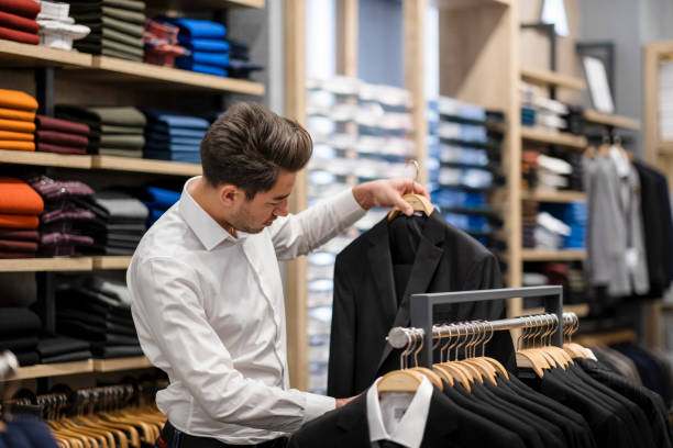 istock Handsome man is choosing clothes in the store 1456515304
