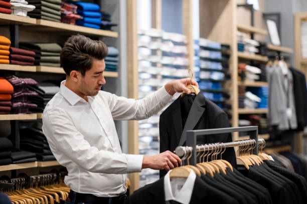 istock Handsome man is choosing clothes in the store 1456515307