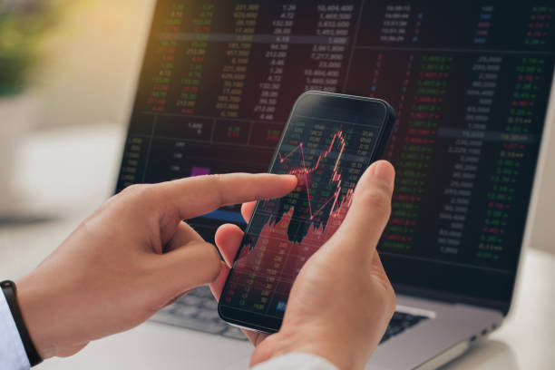 istock Businessmen using smartphones analyze stock exchange market crypto trading decreasing chart data fall down loss, desperate about losing money of crisis, recession, inflation. Economic crisis 1456517737