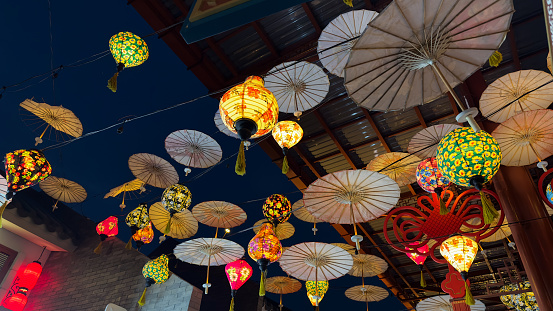 Traditional Chinese patterns and ornaments on the colourful wooden and paper umbrellas. Chinese Lantern Umbrellas. Lunar New Year theme