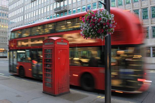 istock Double decker bus in motion and a telephone booth 1456524338