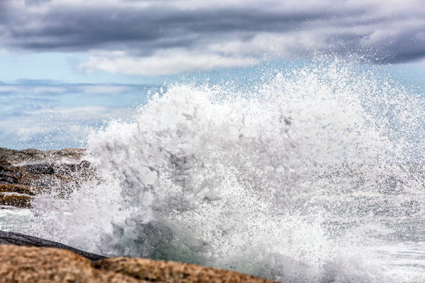 istock Obscured Peggy's Cove Lighthouse Beyond Splashing Storm Surf 1456528360