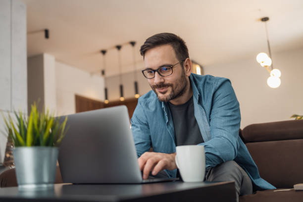 istock Man using laptop, writing email,online meeting or payment online 1456528723