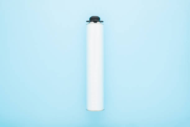 istock Light gray metallic container for professional foam spray gun on light blue table background. Pastel color. Closeup. Top down view. Empty place for text. 1456529924