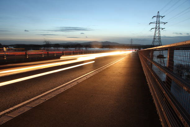 Long exposure of traffic light trails with floodplain and Malvern Hills in background