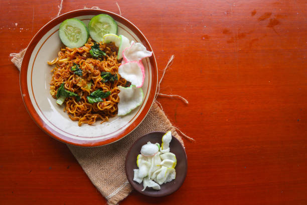 istock mie tek tek or fried noodle made with egg noodles with chicken, cabbage, mustard greens, meatballs, scrambled eggs. indonesian food 1456531081