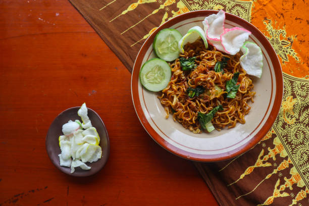 istock mie tek tek or fried noodle made with egg noodles with chicken, cabbage, mustard greens, meatballs, scrambled eggs. indonesian food 1456531088