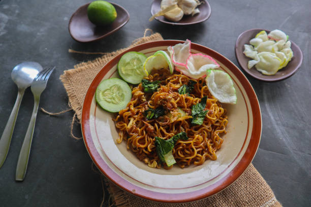istock mie tek tek or fried noodle made with egg noodles with chicken, cabbage, mustard greens, meatballs, scrambled eggs. indonesian food 1456531160