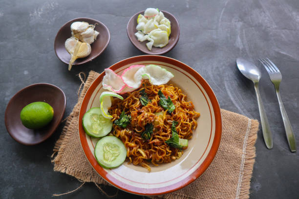 istock mie tek tek or fried noodle made with egg noodles with chicken, cabbage, mustard greens, meatballs, scrambled eggs. indonesian food 1456531163