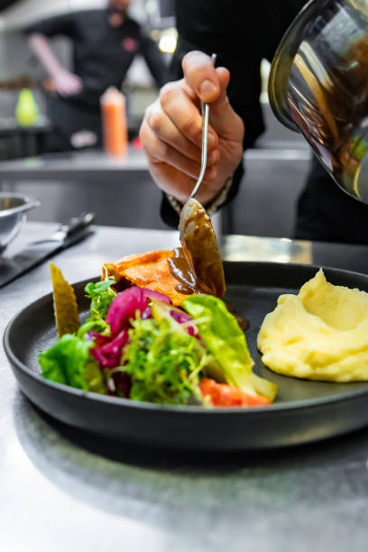 istock chef hand preparing Meat Pie with mashed potato and salad on restaurant kitchen 1456535079