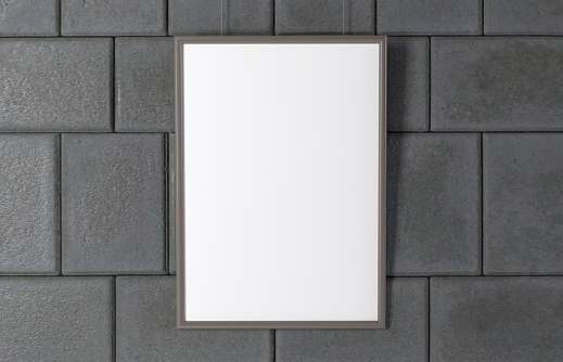 Blank picture frame at the grey wall with copy space and soft sahow