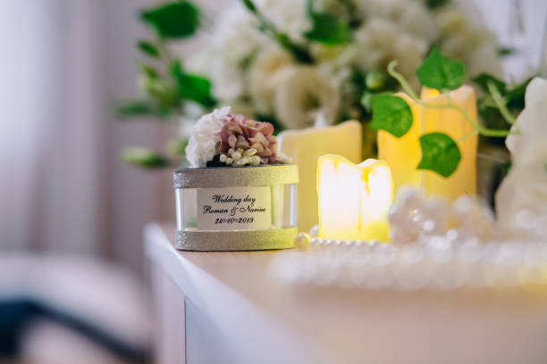 wedding souvenir next to candles on a wooden table