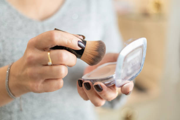 istock Close-up of older woman's hands handling makeup items. 1456536545