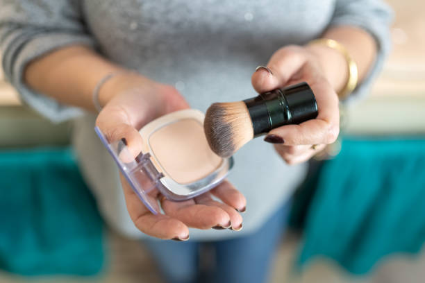 istock Close-up of older woman's hands handling makeup items. 1456536551