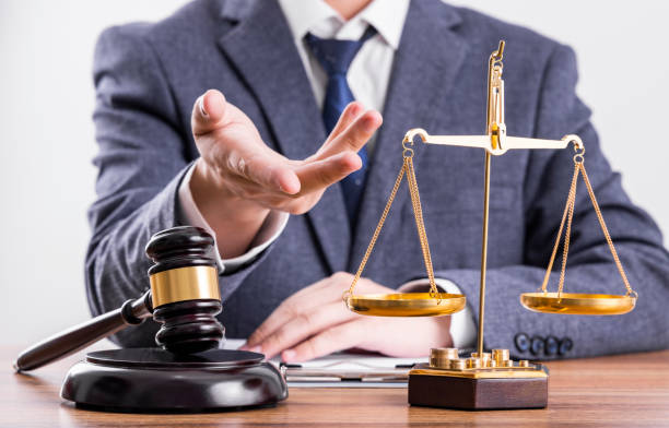 istock Man before the scales and judge hammer 1456542283
