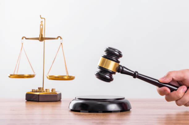 istock The scales and the judge's hammer on the table 1456542294