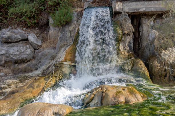 The waters of natural and healing spring Thermopylae flow through rocks and rocks coming out of the ground on an autumn day (Central Greece).