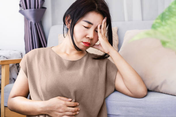 Gut-Brain Axis and anxiety concept,Asian women have problems with digestion systems, stomachache, irritable bowel syndrome ( IBS) stock photo