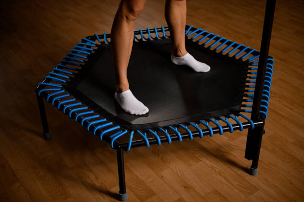 close-up of beautiful muscular female legs on mini trampoline - small gymnastics athlete action imagens e fotografias de stock