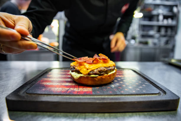 istock chef hand preparing a gourmet burger on restaurant kitchen step by step 1456550823